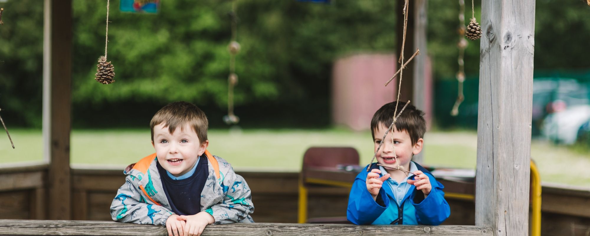 Header image showing children on tricycles